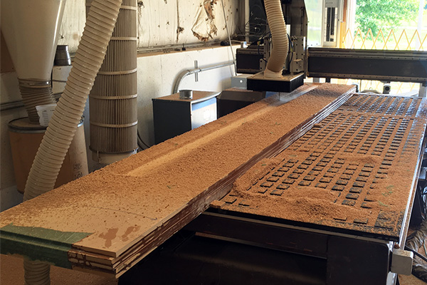 Very long MDF block on CNC router.  Going to re-index it once its half cut.